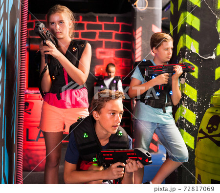 Teen kids during lasertag game Teen kids during lasertag game 72817069