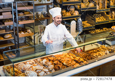 Man baker showing warm tasty croissant Man baker showing warm tasty croissant 72817478