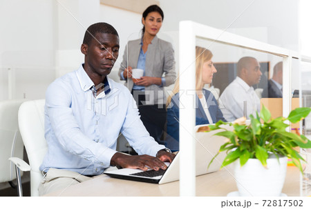positive african male manager in white office 72817502