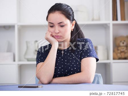 Girl waiting for phone call Girl waiting for phone call 72817745