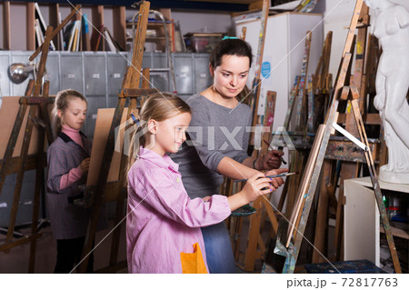Teacher helping teenage students Teacher helping teenage students 72817763