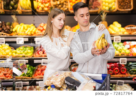 Two customers choosing fruits in grocery 72817764