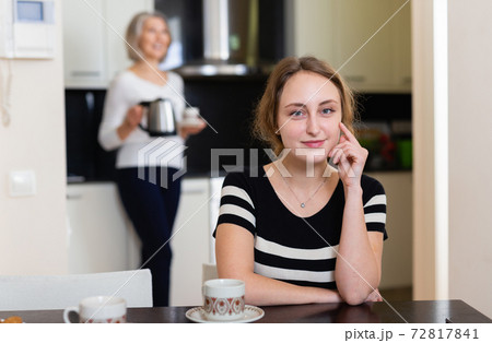 Woman at kitchen table Woman at kitchen table 72817841