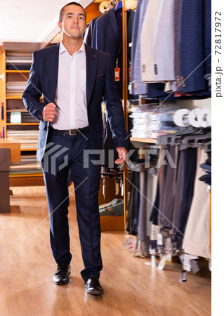 Stylish young man visiting men clothes store 72817972