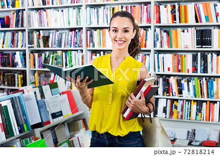 Woman standing with open in publishers store 72818214
