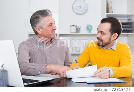 Adult man and agent discuss contract 72818477