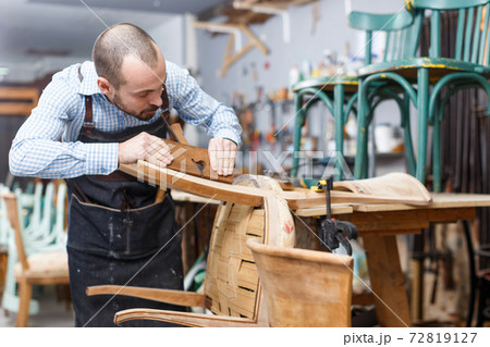 Craftsman using carpentry tools for restoration 72819127