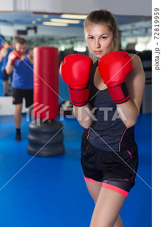 Portrait of woman who is training in box gym. Portrait of woman who is training in box gym. 72819959