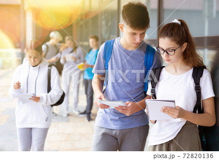 Boy and girl discuss homework after college 72820136