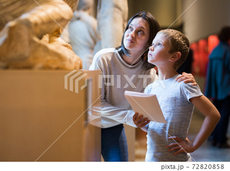 Woman and boy visiting sculptures exhibition 72820858
