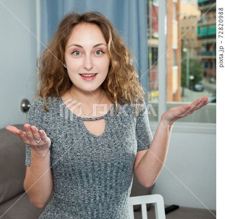 Smiling woman posing in living room interior 72820988