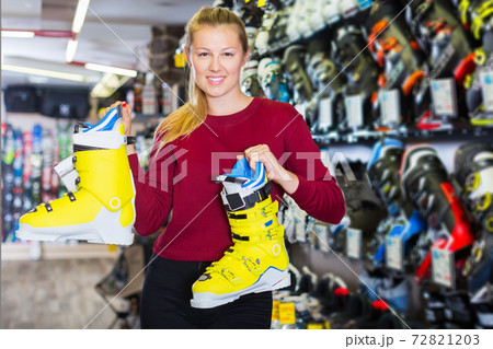 girl is demonstrating boots for skiing girl is demonstrating boots for skiing 72821203