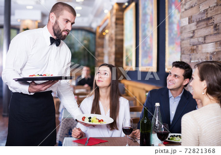waiter man serving company at restaurant waiter man serving company at restaurant 72821368