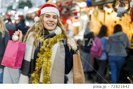 Woman holding bags with Christmas toys Woman holding bags with Christmas toys 72821642