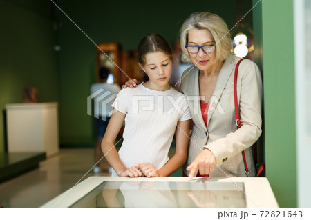 Woman and girl visiting museum 72821643