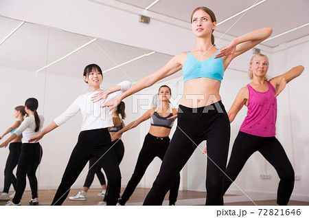 Fitness women practicing zumba movements 72821646