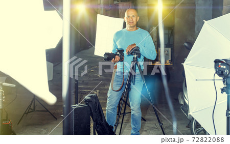 Professional photographer holding camera 72822088