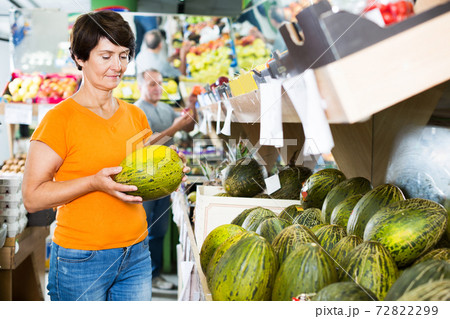 Female is choosing green melons Female is choosing green melons 72822299