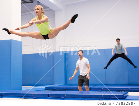 Woman jumping in trampoline center Woman jumping in trampoline center 72822887