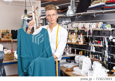 Tailor showing dress on hanger Tailor showing dress on hanger 72822893