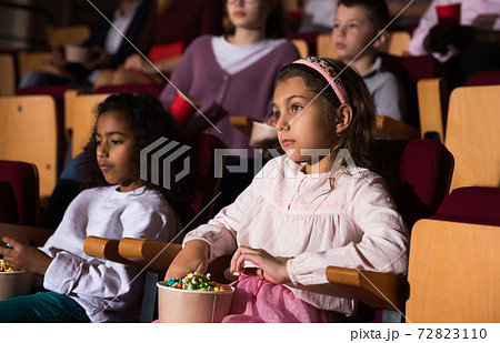 little female viewer sitting at premiere in cinema little female viewer sitting at premiere in cinema 72823110