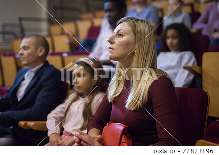 Woman watching theatrical performance in theater hall 72823196