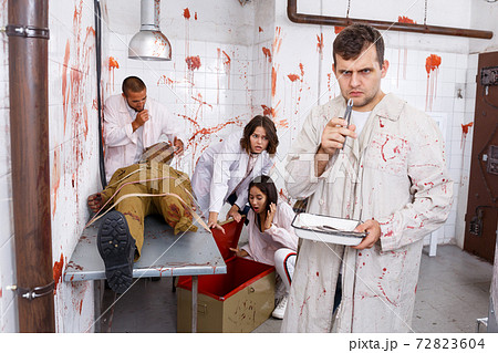 Young man in quest room with bloody traces Young man in quest room with bloody traces 72823604