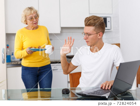 Guy refusing cookies that mom offering Guy refusing cookies that mom offering 72824054