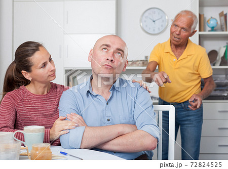 Wife calms husband after his quarrel with father 72824525