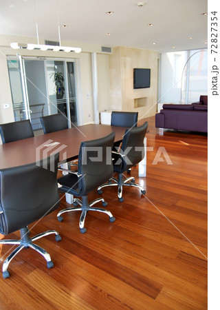 Empty meeting table and chairs in a modern conference room. Business meetings and ideas can be exchanged. Empty meeting table and chairs in a modern conference room. Business meetings and ideas can be exchanged. 72827354
