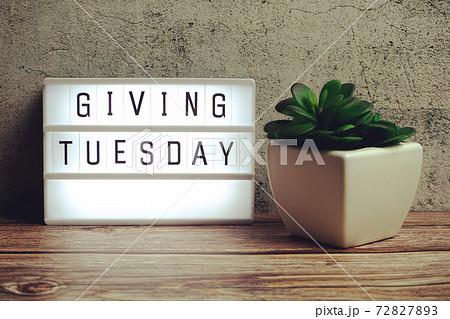 Giving Tuesday word in light box on wooden background 72827893