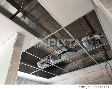 KUALA LUMPUR, MALAYSIA -APRIL 26, 2020: Installation of suspended ceiling frame and finishes. All the above-ceiling services and equipment. installed before that. All the installation work to be coord KUALA LUMPUR, MALAYSIA -APRIL 26, 2020: Installation of suspended ceiling frame and finishes. All the above-ceiling services and equipment. installed before that. All the installation work to be coord 72832173