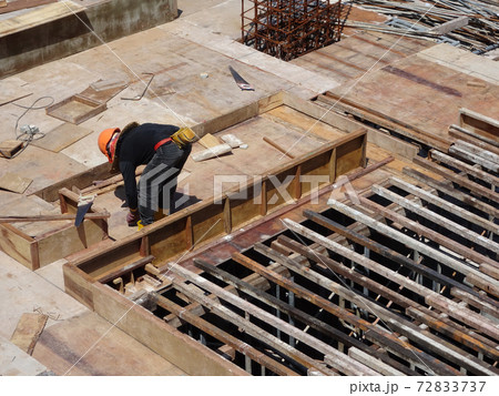 KUALA LUMPUR, MALAYSIA -JULY 16, 2017: Carpenters fabricate timber and plywood formwork at the construction site. Timber formwork as a mold to the reinforced concrete structure. 72833737