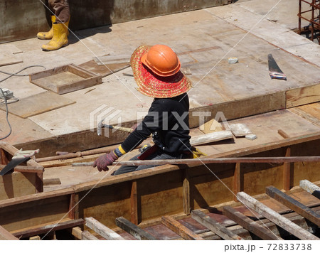 KUALA LUMPUR, MALAYSIA -JULY 16, 2017: Carpenters fabricate timber and plywood formwork at the construction site. Timber formwork as a mold to the reinforced concrete structure. KUALA LUMPUR, MALAYSIA -JULY 16, 2017: Carpenters fabricate timber and plywood formwork at the construction site. Timber formwork as a mold to the reinforced concrete structure. 72833738