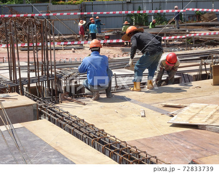 KUALA LUMPUR, MALAYSIA -JULY 16, 2017: Carpenters fabricate timber and plywood formwork at the construction site. Timber formwork as a mold to the reinforced concrete structure. 72833739