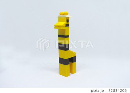 The shape of a giraffe made from colorful plastic toy bricks isolated on white background.  72834206