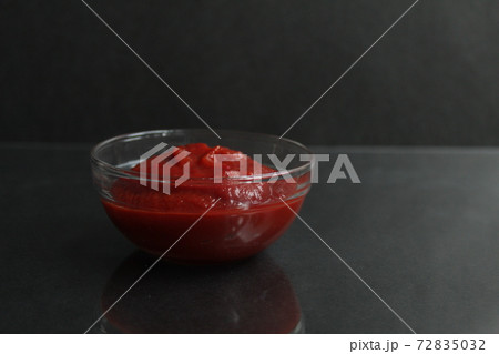 red tomato sauce paste in a glass sauce bowl on a black background copy space place for text red tomato sauce paste in a glass sauce bowl on a black background copy space place for text 72835032