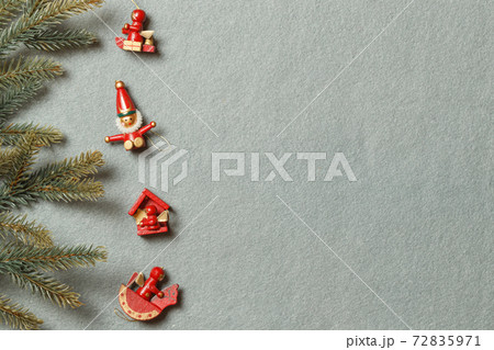 Vintage wooden toys for the Christmas tree on a gray background and fir branches. The layout of the space 72835971