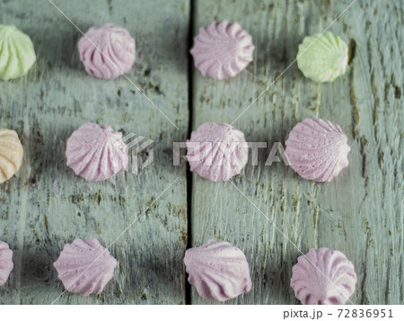 Meringue cakes on wooden background 72836951