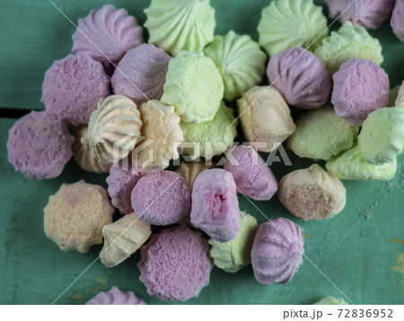 Meringue cakes on wooden background 72836952