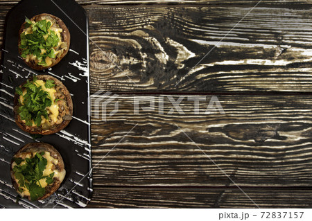 Stuffed mushrooms on a rough wooden surface Stuffed mushrooms on a rough wooden surface 72837157