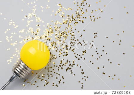One yellow decorative lamp on a gray background. One yellow decorative lamp on a gray background. 72839508