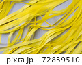 Abstract gray background with bright yellow wavy paper stripes. 72839510