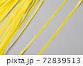 Abstract gray background with bright yellow wavy paper stripes. 72839513