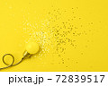 One yellow decorative lamp on a gray background. 72839517