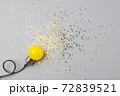 One yellow decorative lamp on a gray background. 72839521