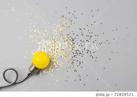 One yellow decorative lamp on a gray background. One yellow decorative lamp on a gray background. 72839521