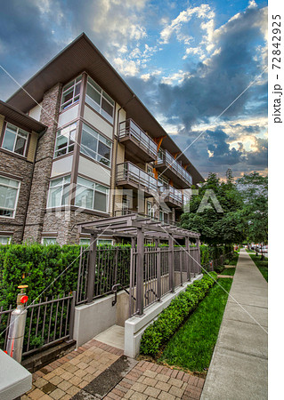 Corner of residential building on cloudy sky background 72842925