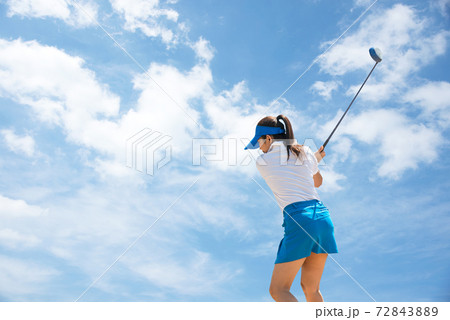 Golfer sport course golf ball fairway. People lifestyle woman playing game golf tee of blue sky background. 72843889