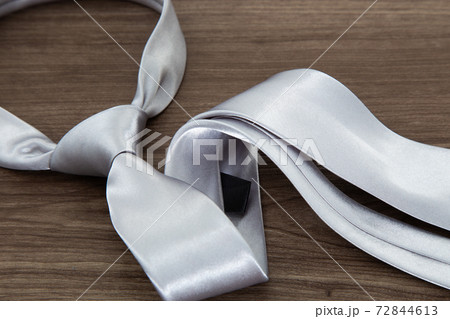 Silver color necktie on table 72844613
